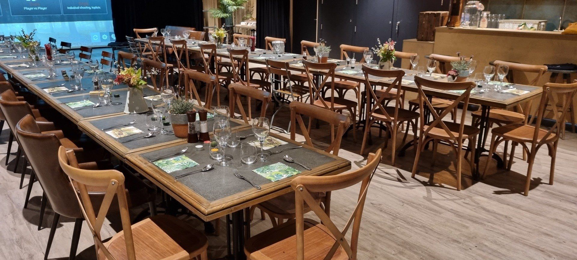 There are many tables and chairs in the room.