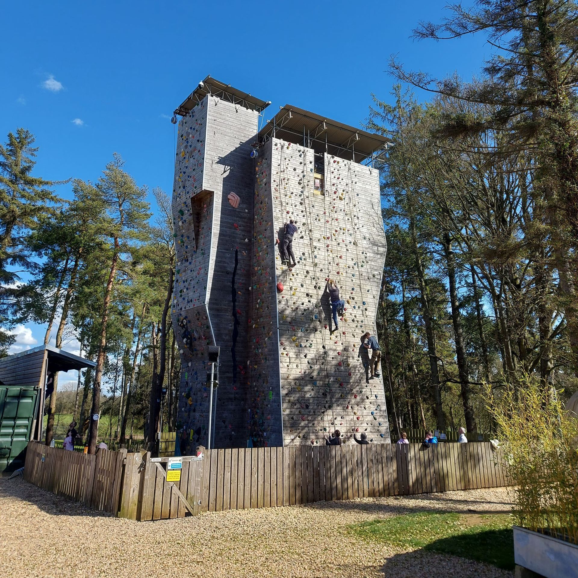 A group of people are climbing a large rock wall