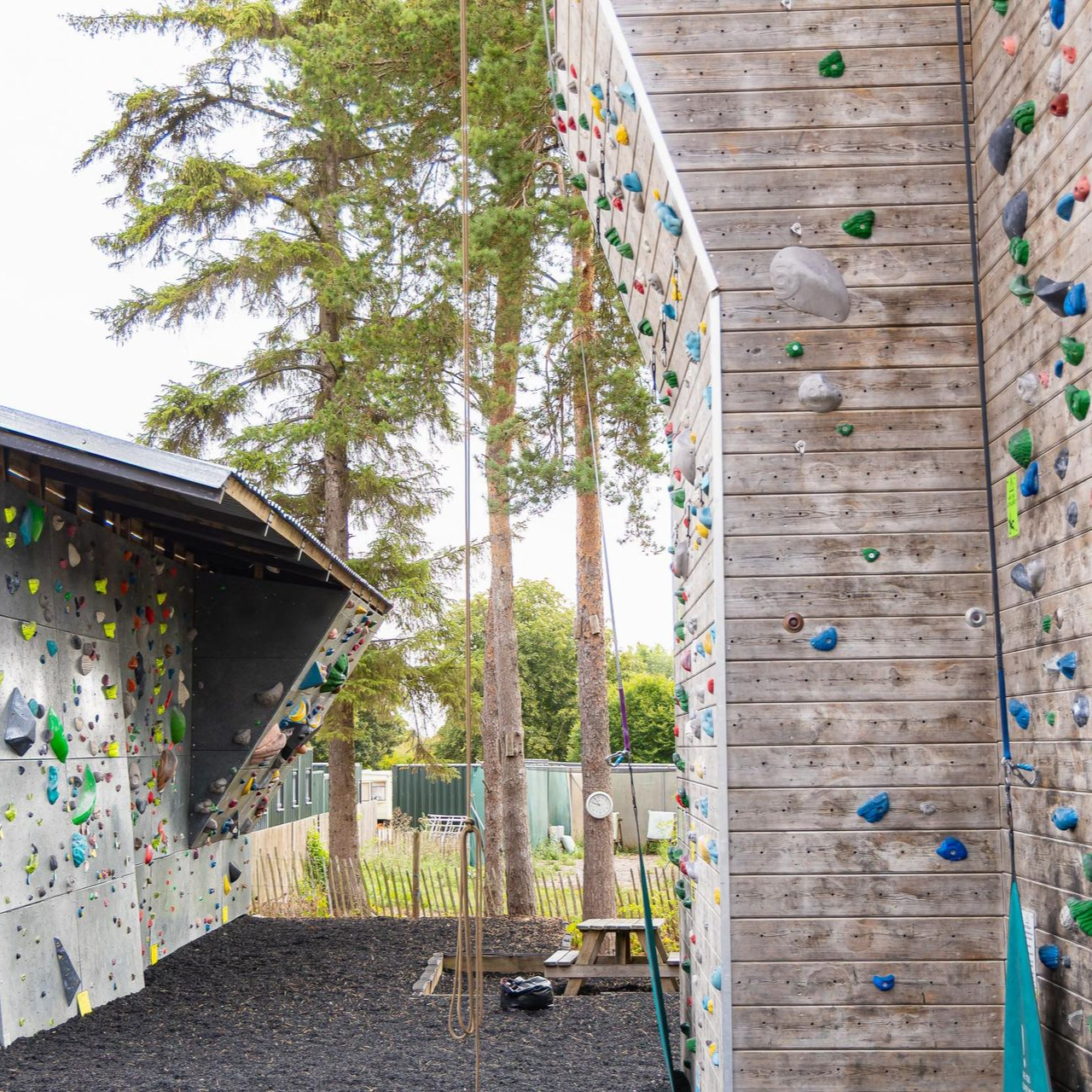 A group of people are climbing a climbing wall.