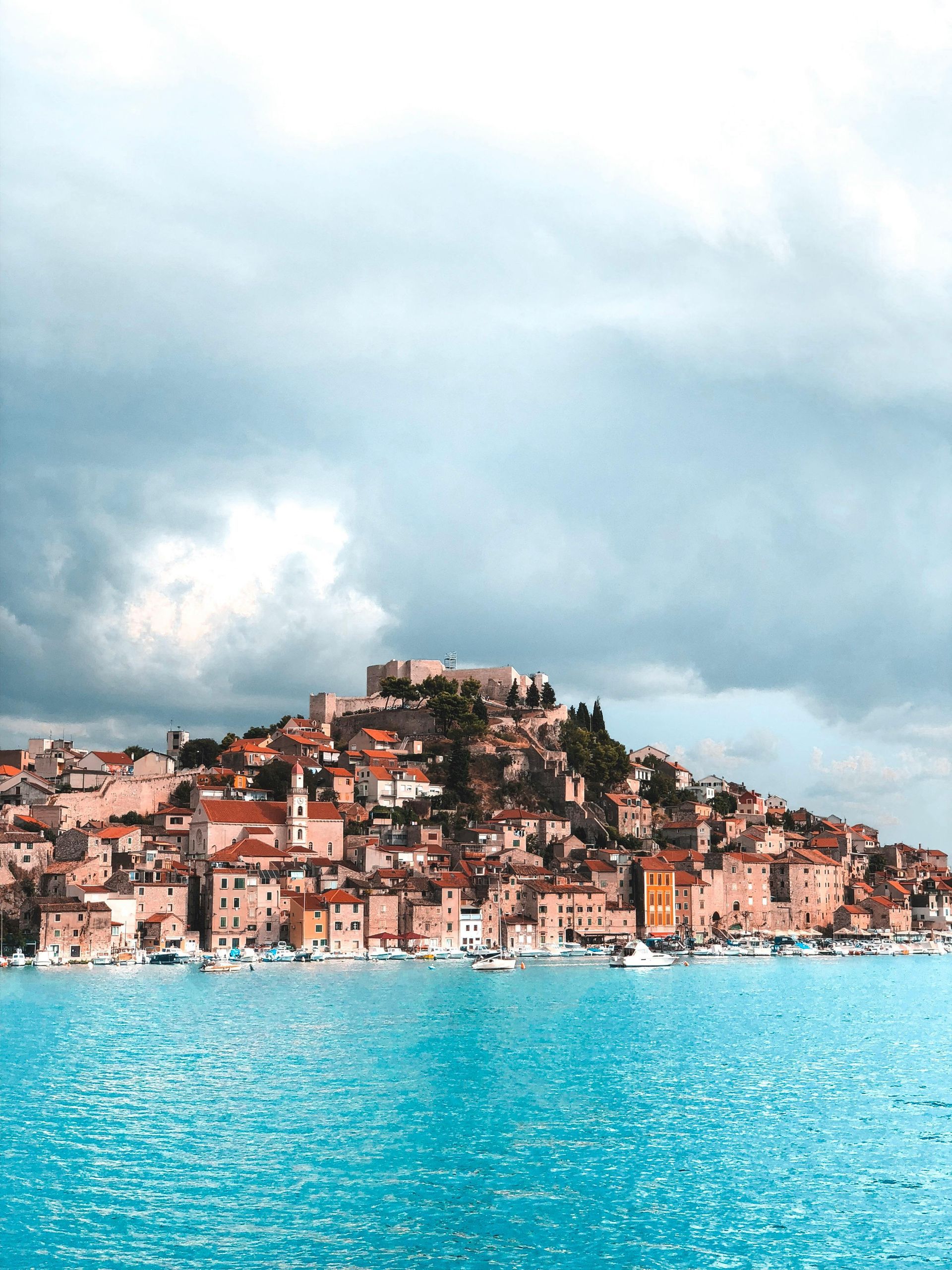 A city on a hill overlooking a body of water.