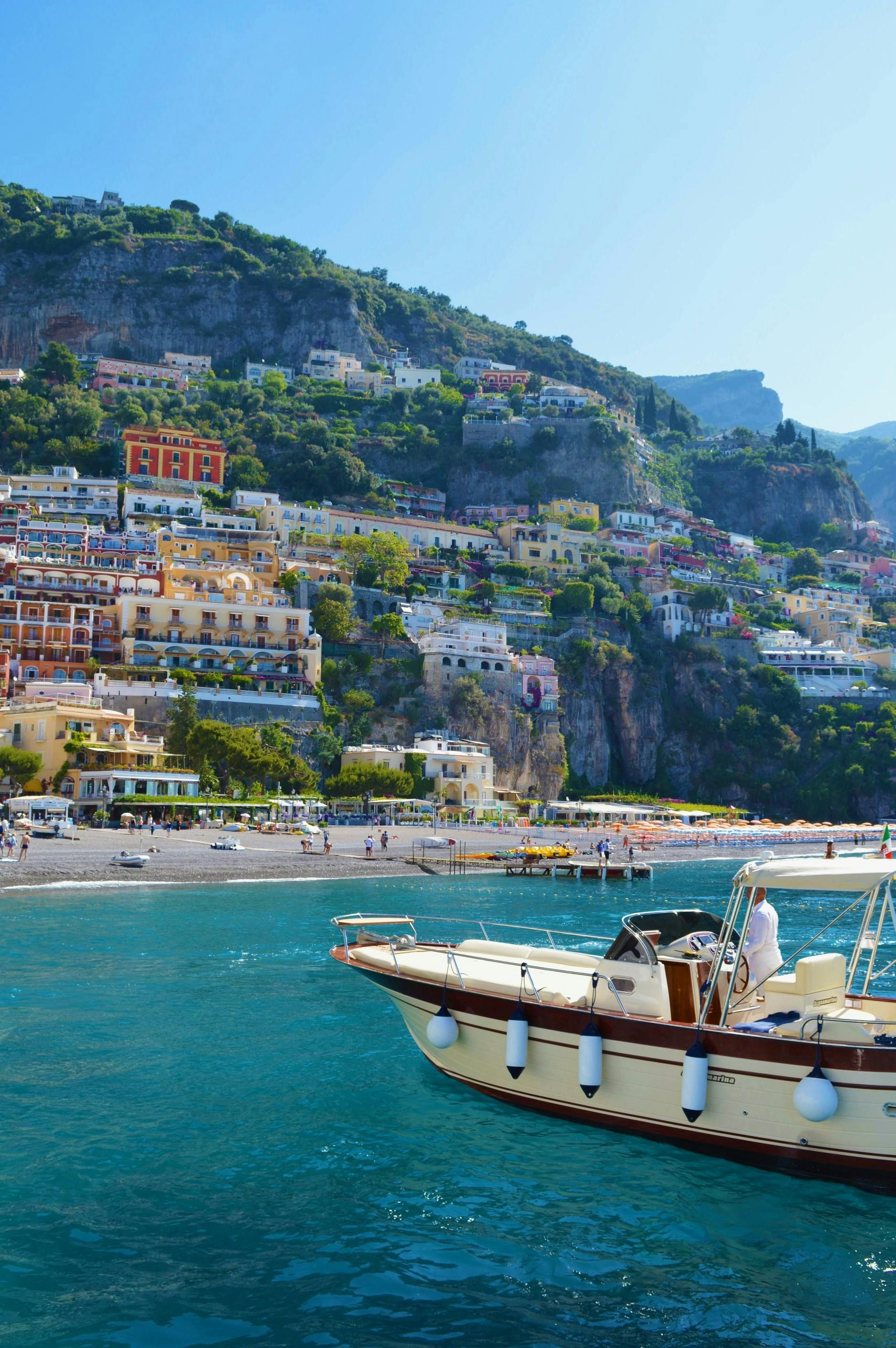 A boat in the water with a city in the background