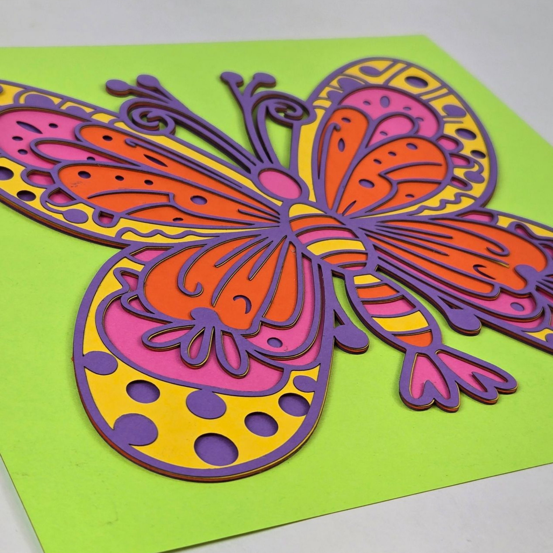 Layered laser cut butterfly with colorful painted sections.
