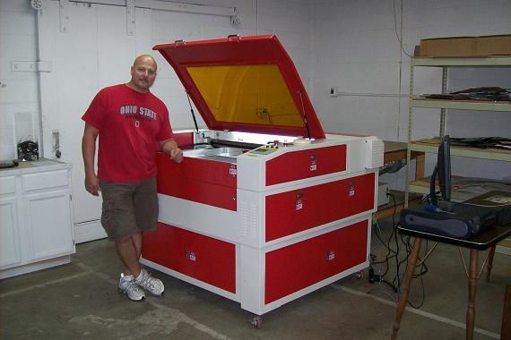 man posing next to their rabbit laser usa machine 
