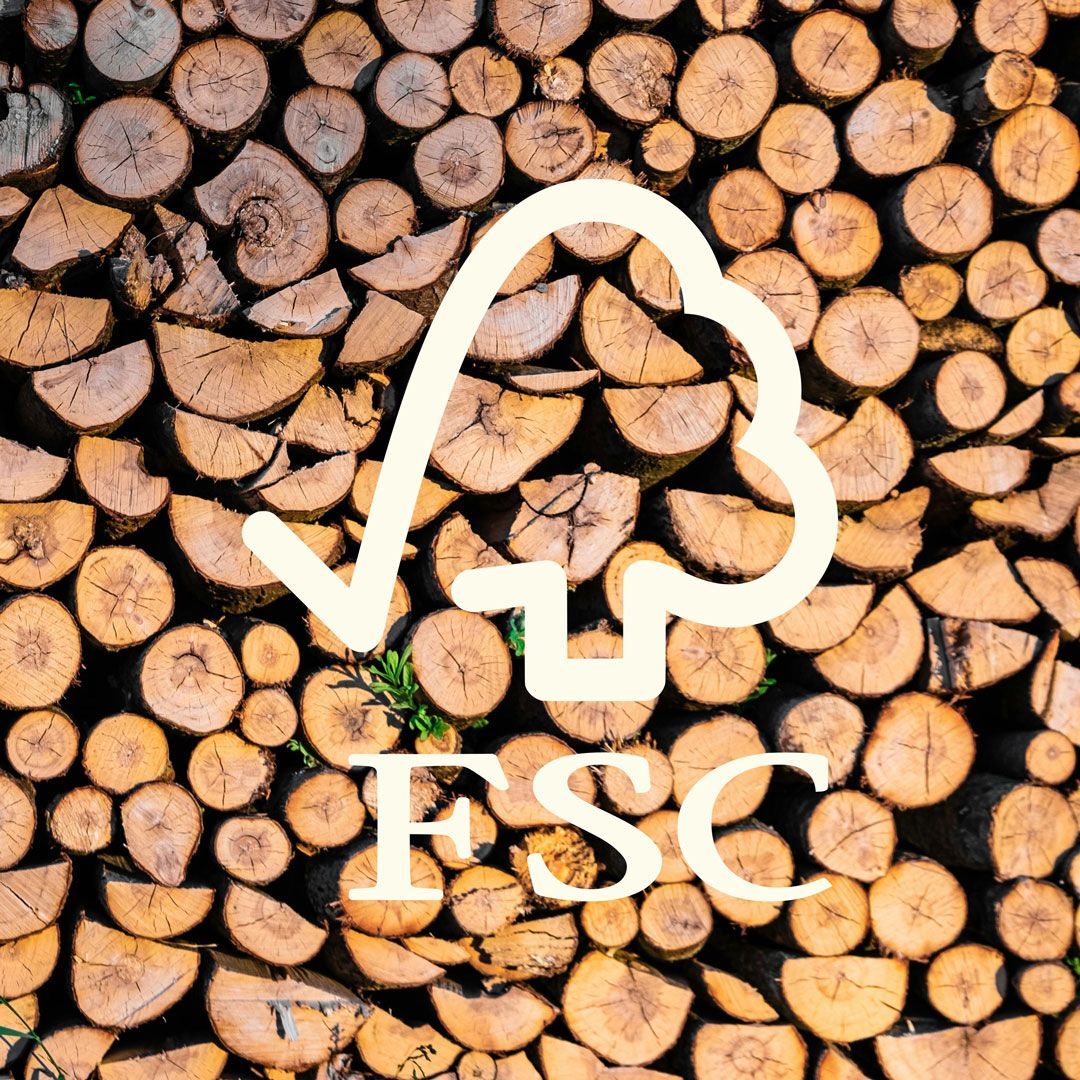 Stacked wood logs with FSC symbol representing responsibly sourced wood materials