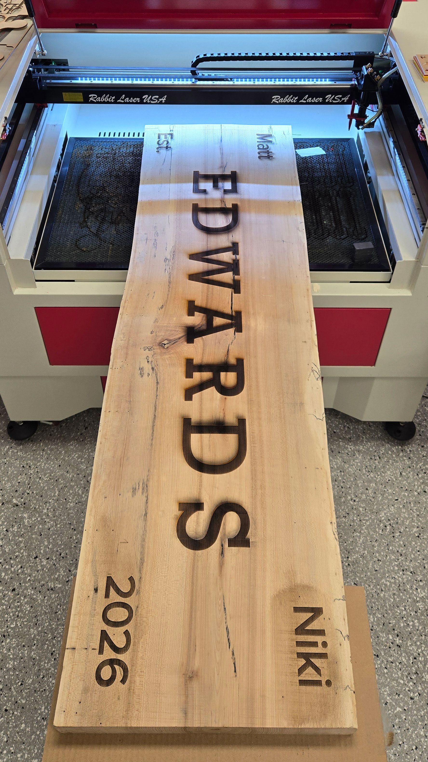 Finished 62-inch wooden bench back engraved across three sections using an SD-60-9060 laser engraver.
