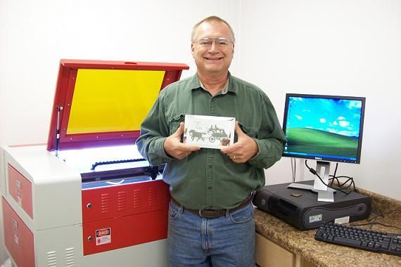 man posing next to their rabbit laser usa machine 