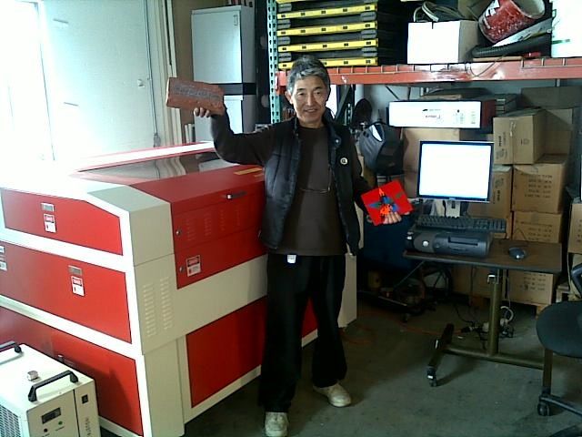 happy customer posing with a finished project in front of their rabbit laser usa