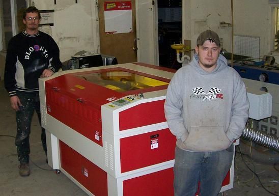men posing next to their rabbit laser usa machine 