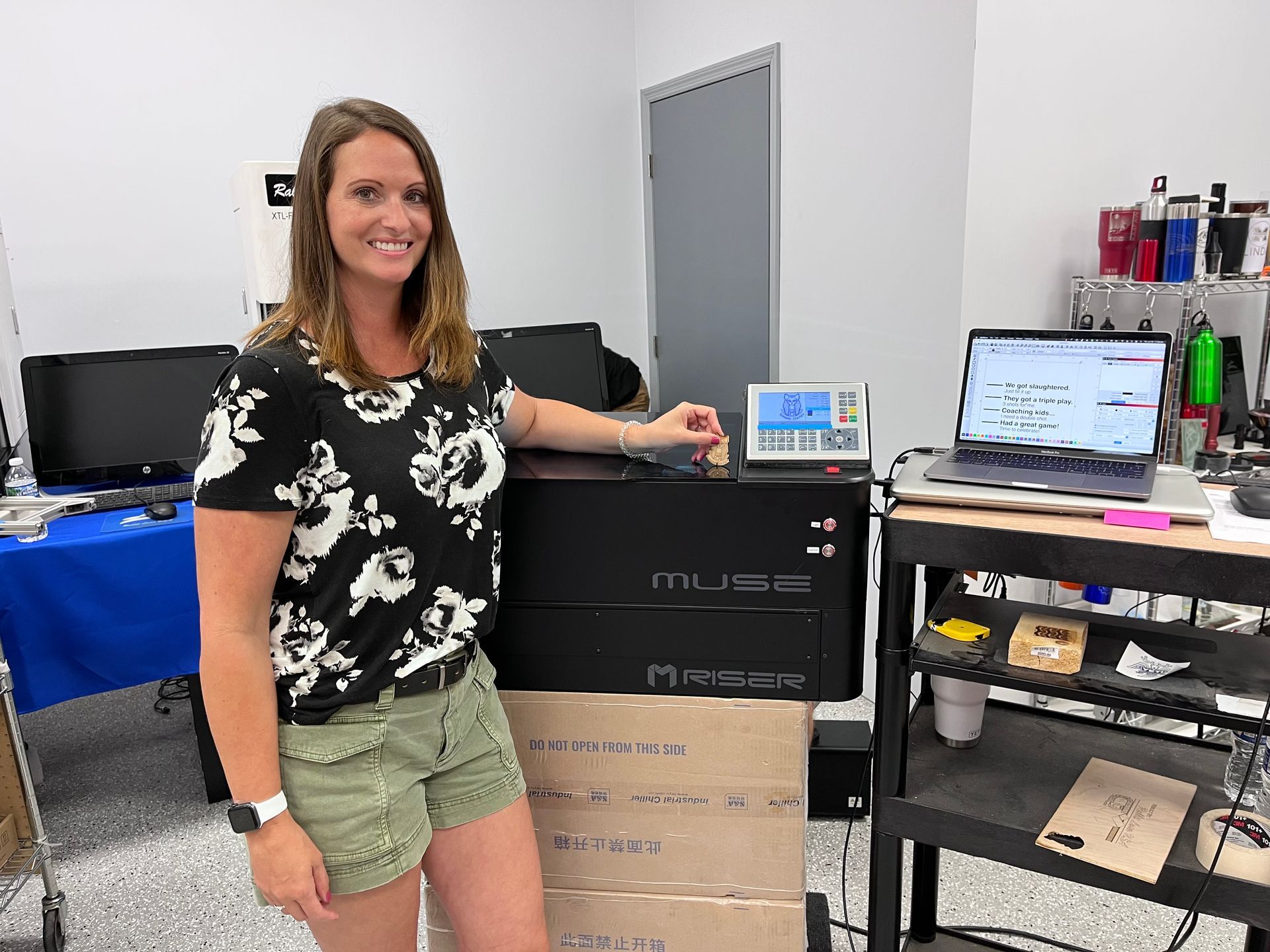 happy customer posing with their rebuilt Full Spectrum Laser by Rabbit Laser USA