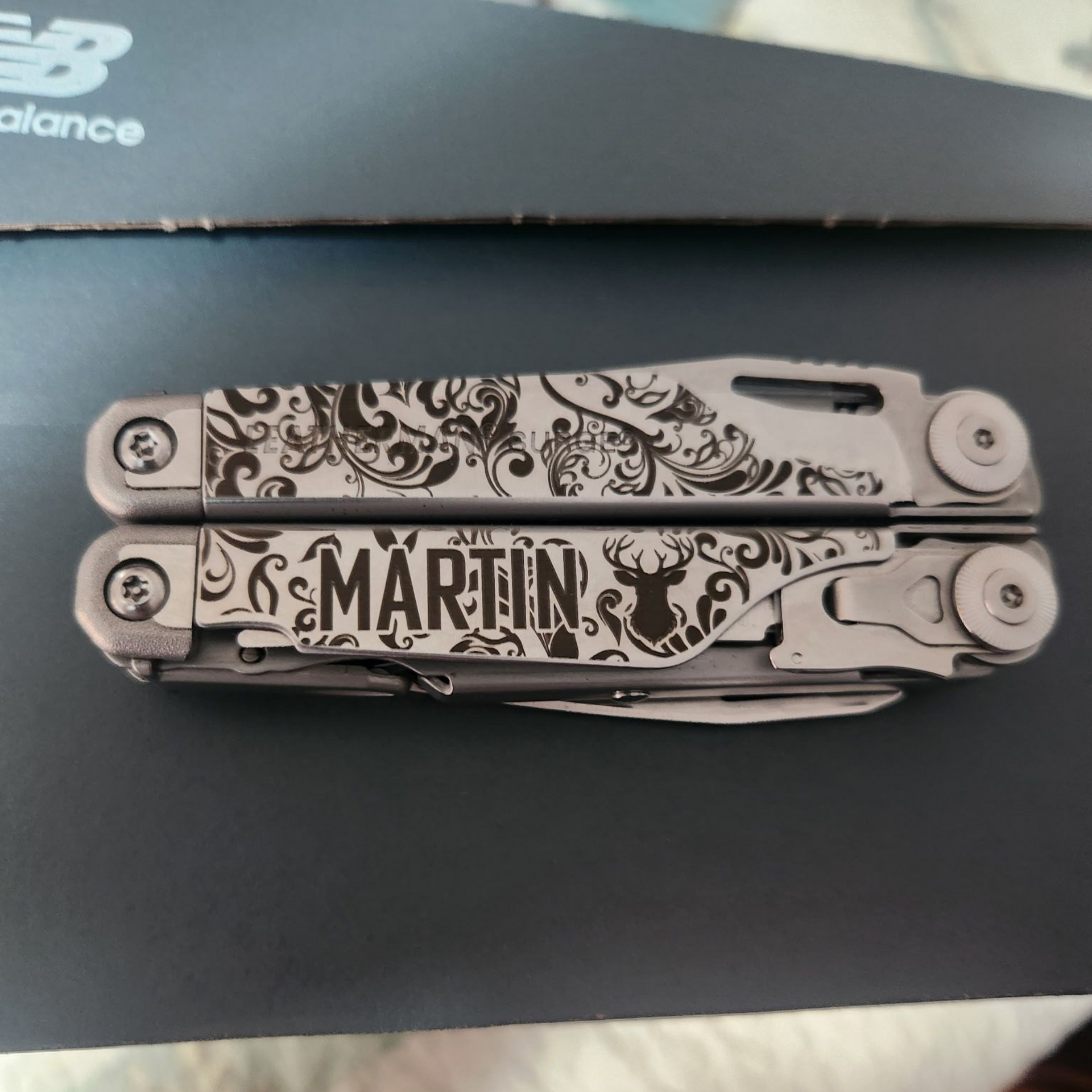 Custom engraved multitool with floral pattern, deer silhouette, and personalized name
