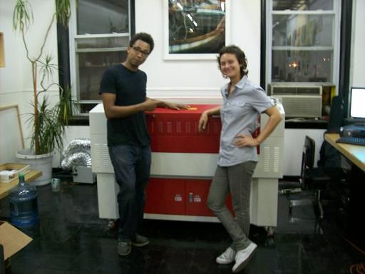 man and woman posing next to their rabbit laser usa machine 