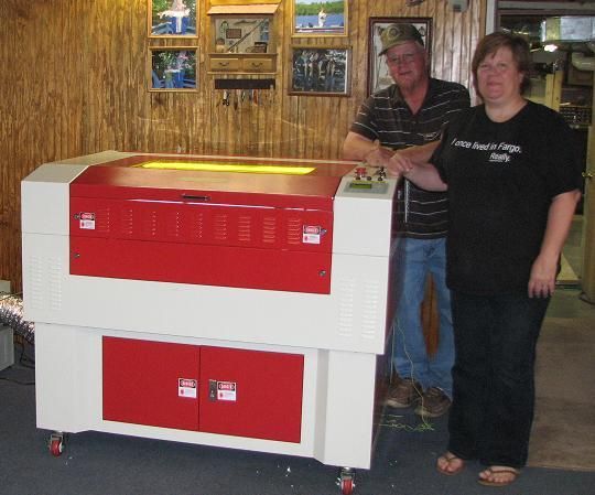 couple posing next to their rabbit laser usa machine 