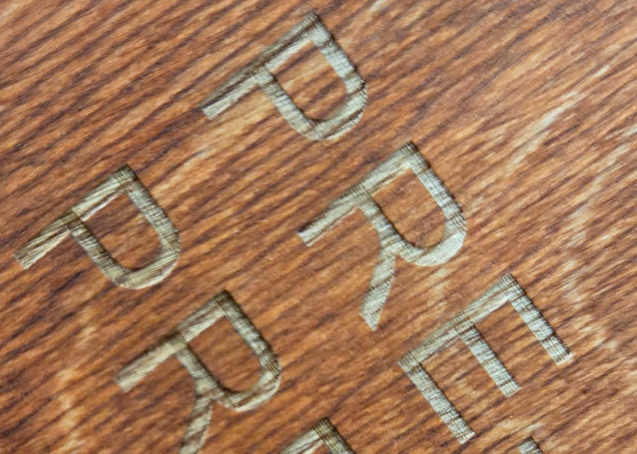close up of wood engraved after staining.