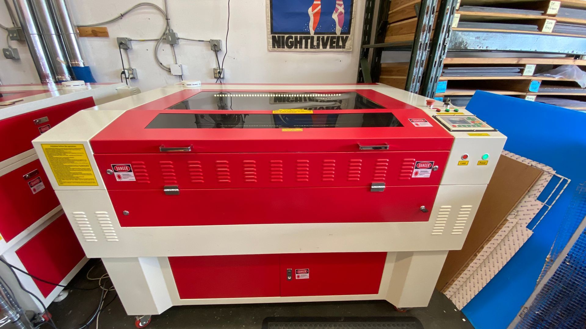 Used RL-80-1290 CO2 laser with red and white cabinet, viewing window, and control panel