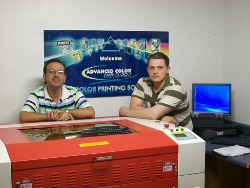 men posing next to their rabbit laser usa machine 