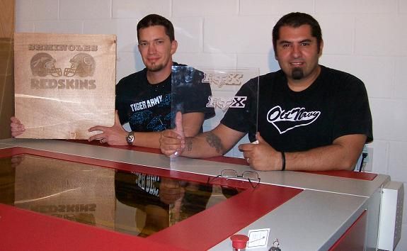 men posing next to their rabbit laser usa machine 