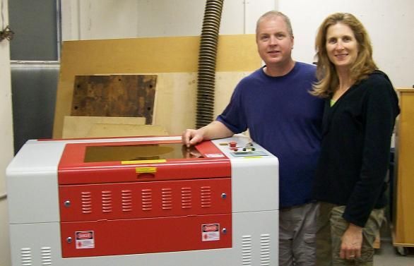 couple posing next to their rabbit laser usa machine 
