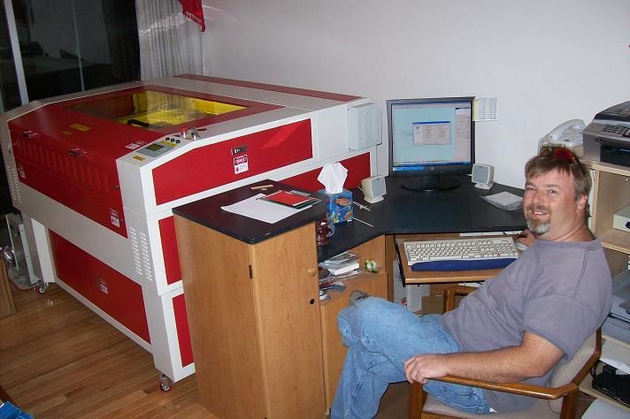 man posing next to their rabbit laser usa machine 