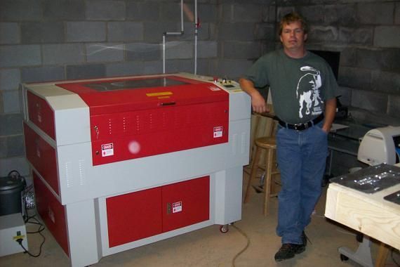man posing next to their rabbit laser usa machine 