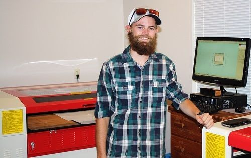 happy customer standing in front of their rabbit laser usa machine