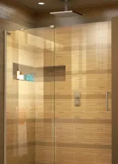 Modern glass shower enclosure in a warm-toned tiled bathroom