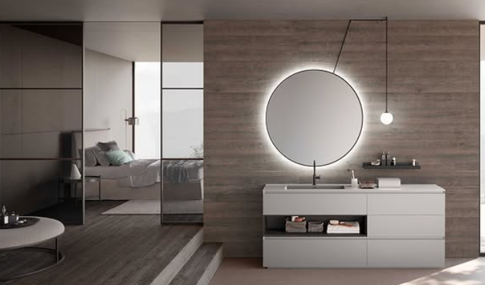 Camera da letto moderna e minimalista con mobiletto bianco, specchio rotondo, parete con inserti in legno e delicate tonalità neutre.