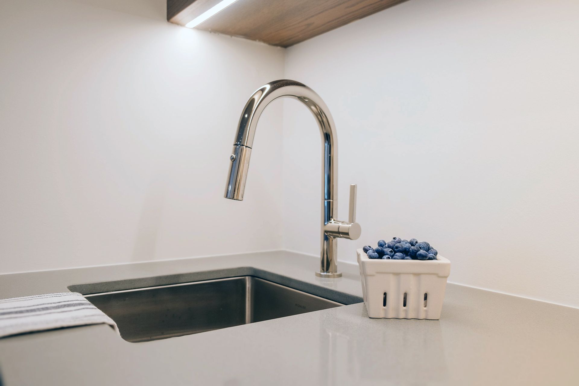 A kitchen sink with a silver faucet.