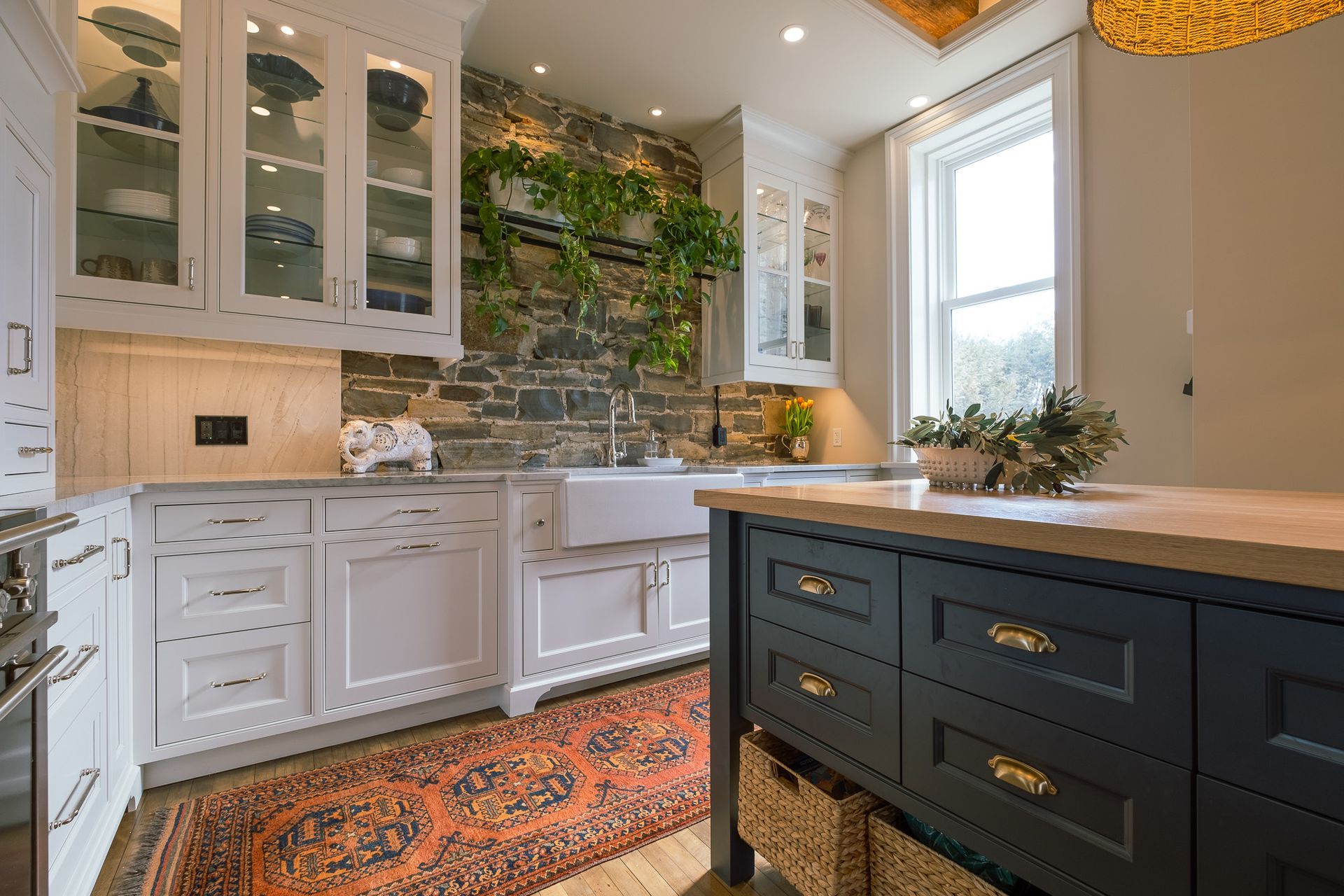 A kitchen with white cabinets, a sink, and a rug.