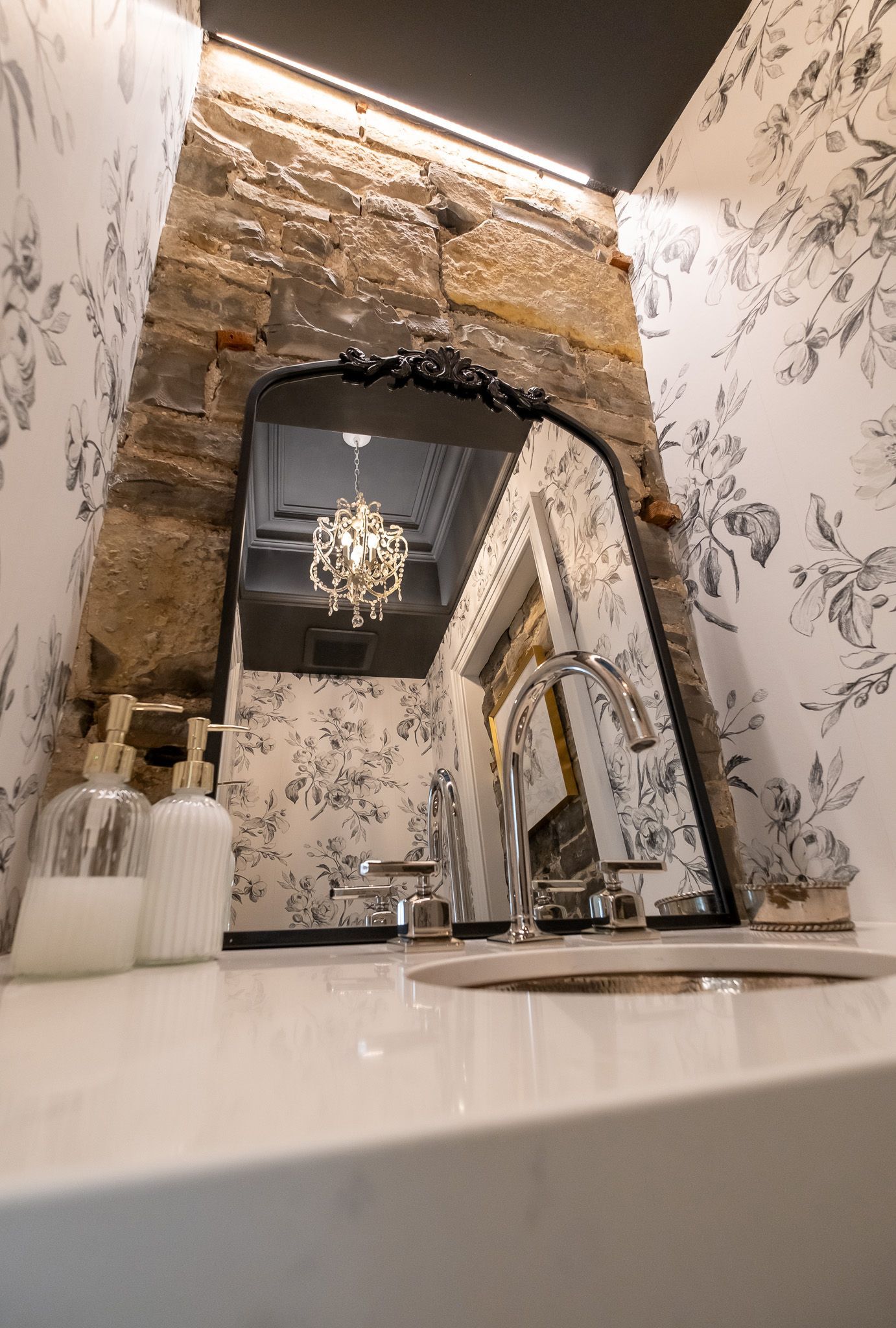 A bathroom with a sink and a mirror.