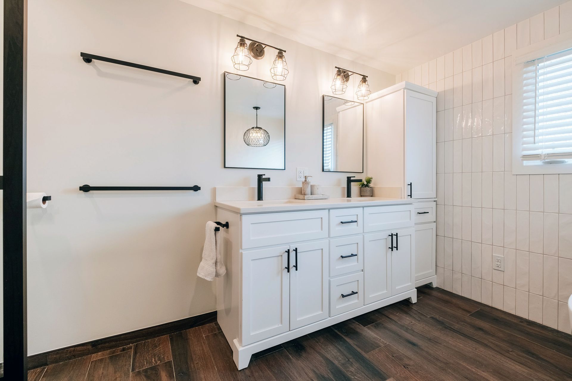 A bathroom with two sinks and two mirrors.