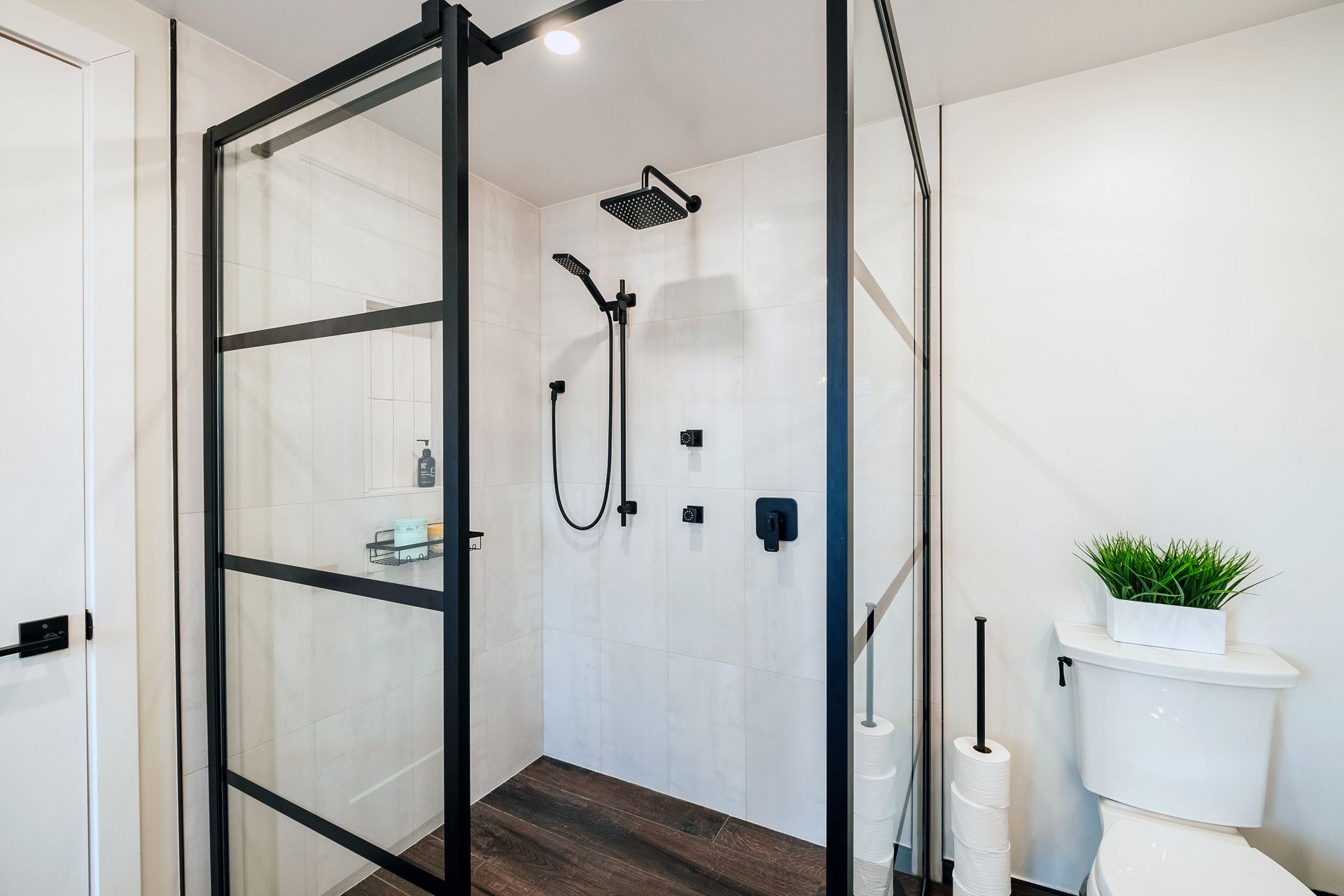 A bathroom with a walk in shower and a toilet.