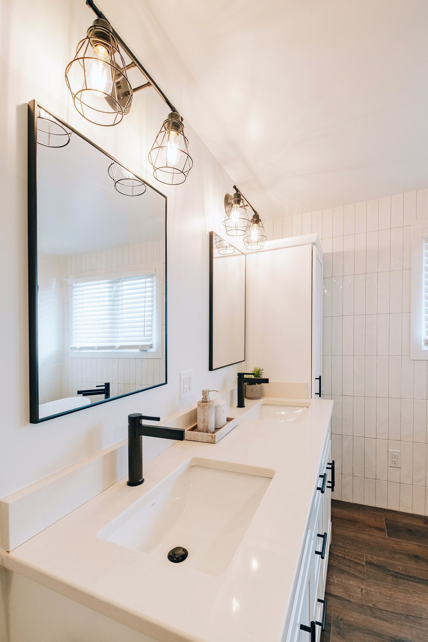 A bathroom with two sinks and two mirrors.