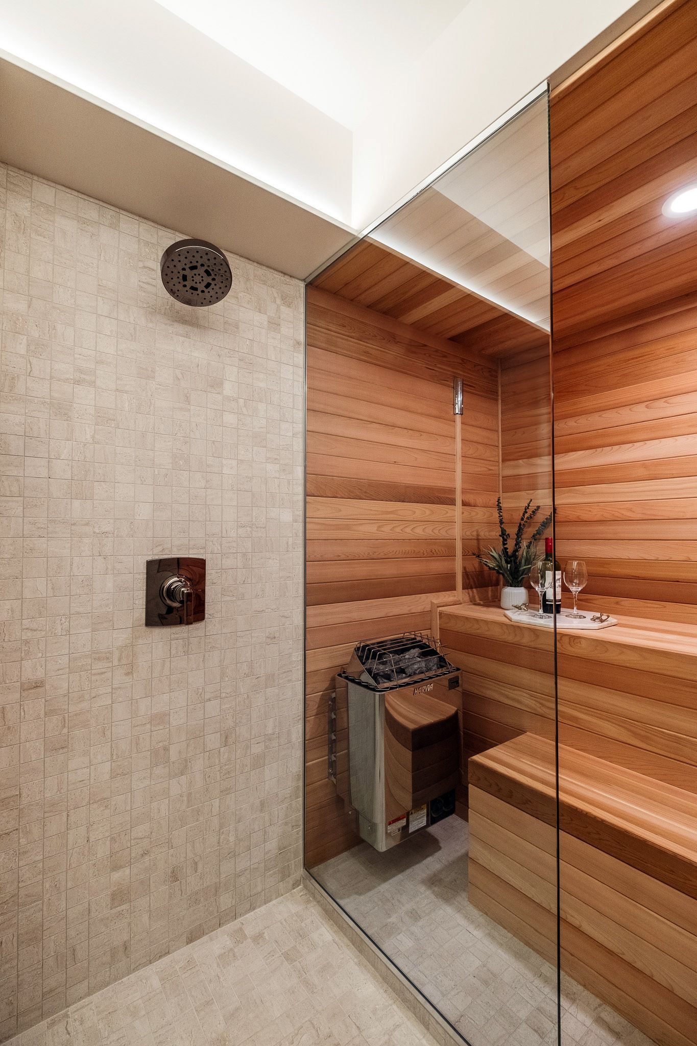 A bathroom with a walk in shower and a sauna.