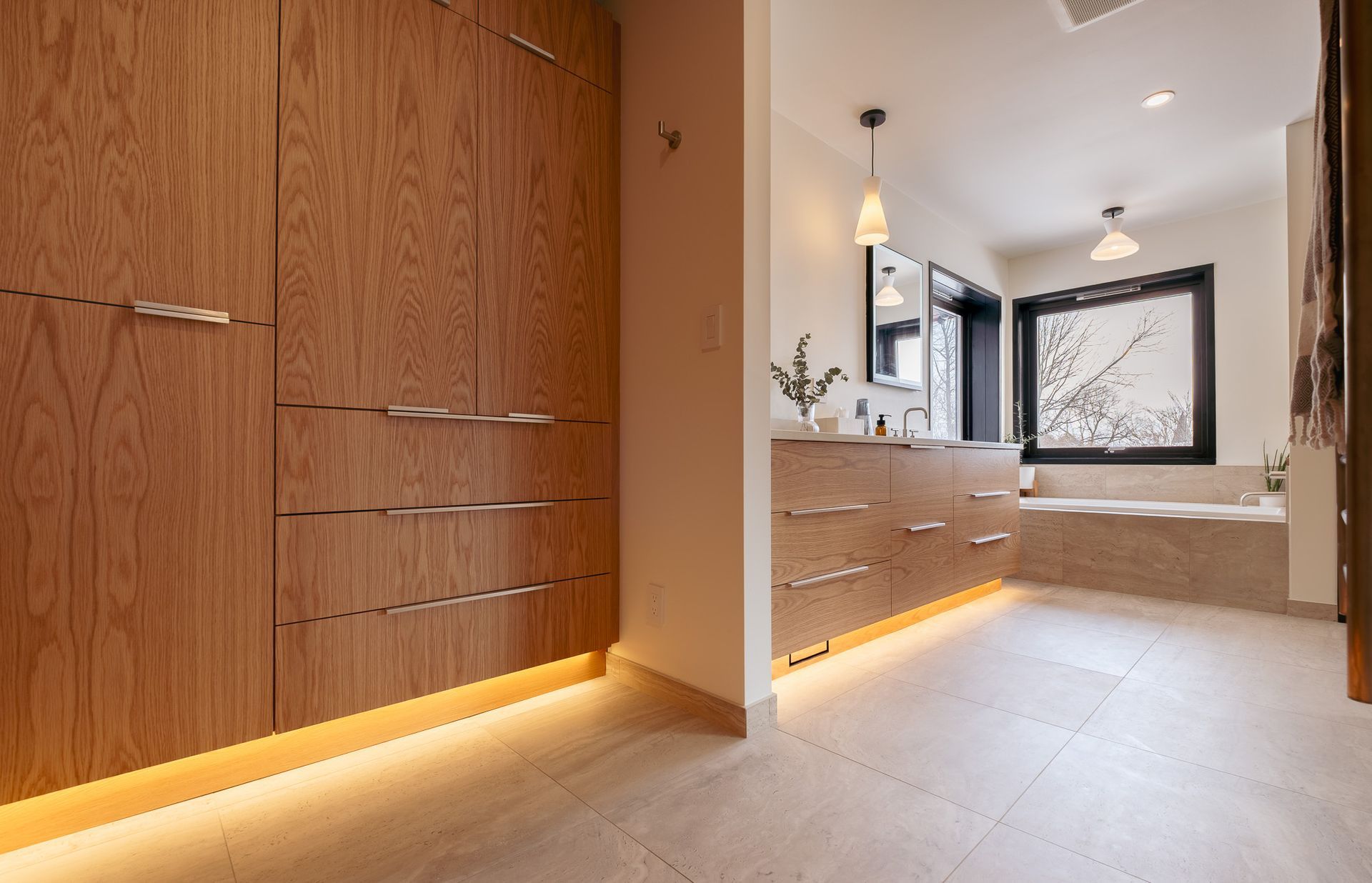 A bathroom with wooden cabinets and a bathtub.