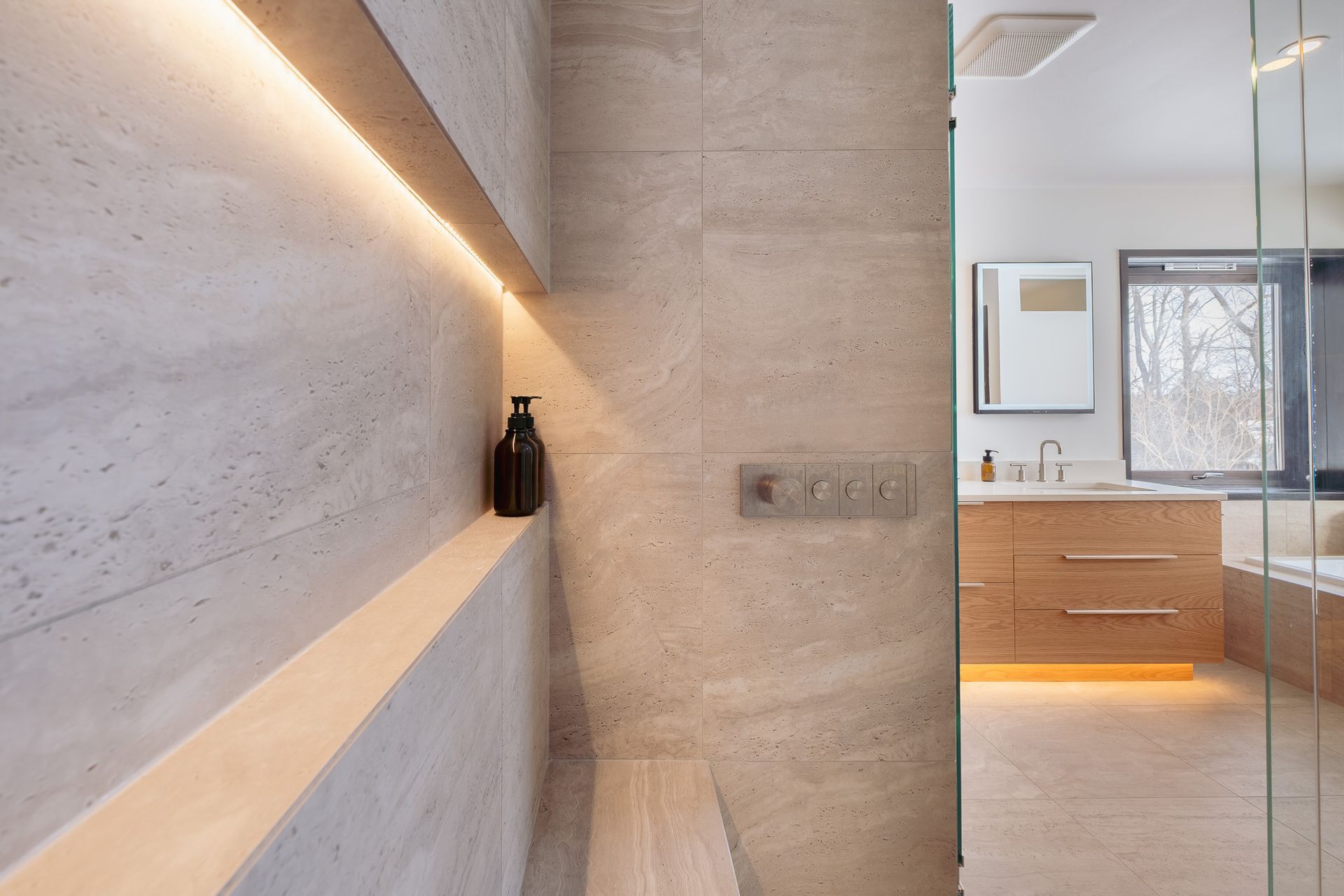 A bathroom with a walk in shower and a sink.