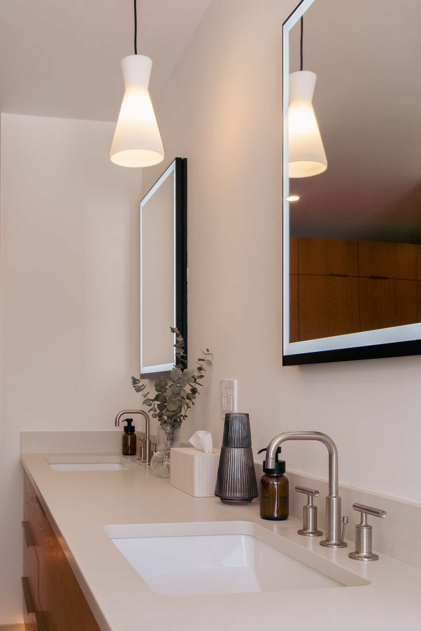 A bathroom with two sinks and two mirrors.