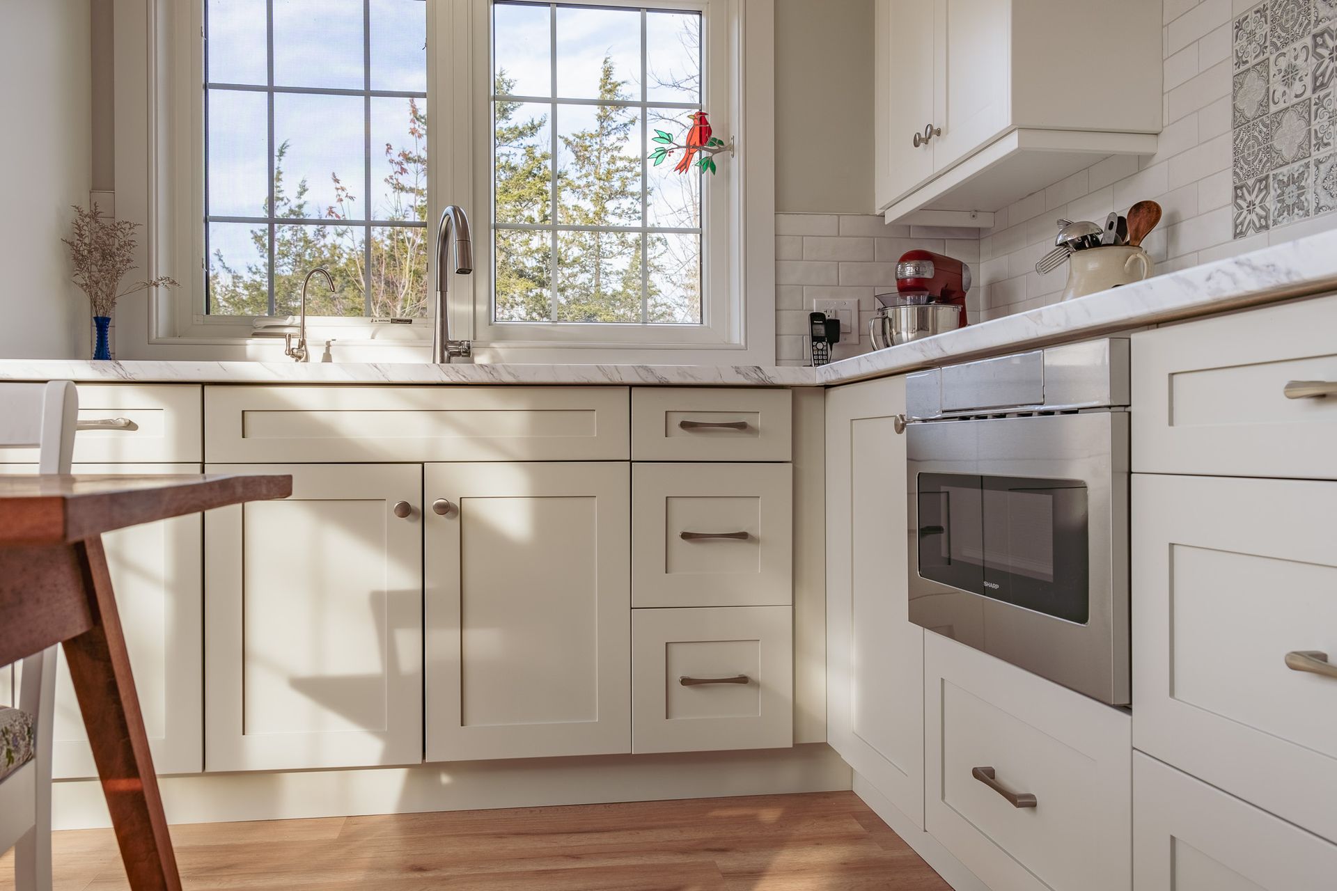 A kitchen with white cabinets and stainless steel appliances.