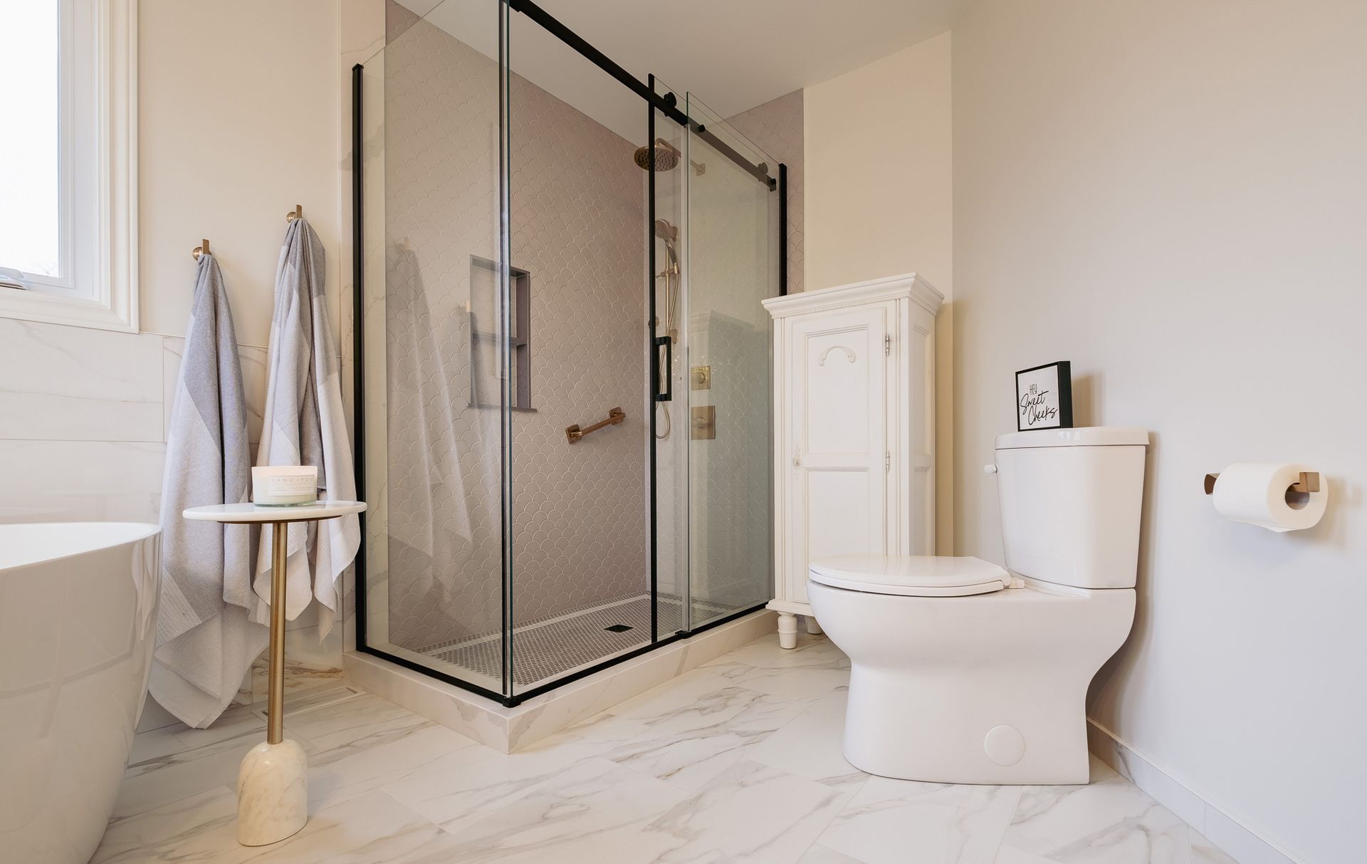 A bathroom with a toilet, bathtub, and shower.