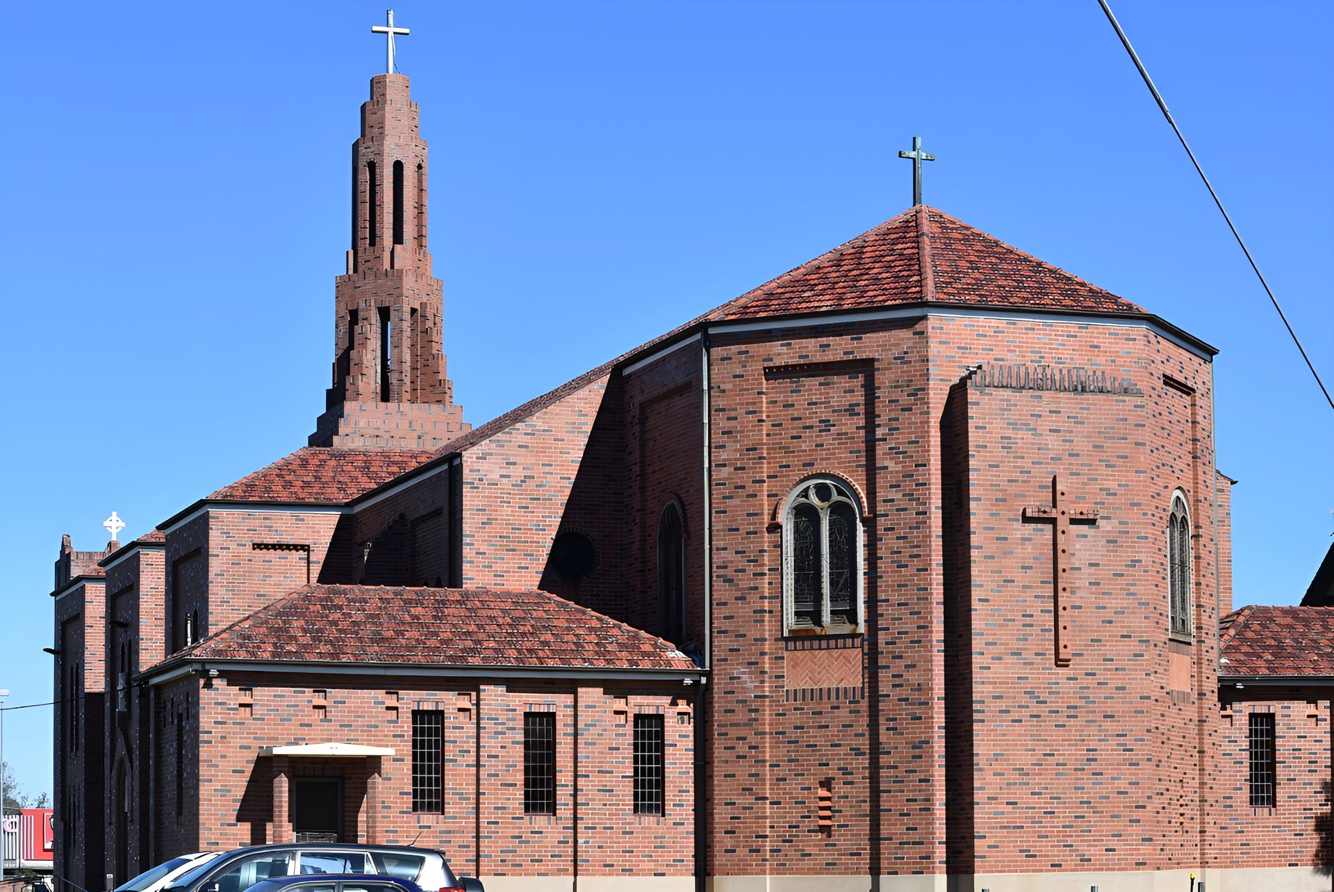 A Large Brick Church With a Cross on Top of It — Carpet Pro Care in Casino, NSW
