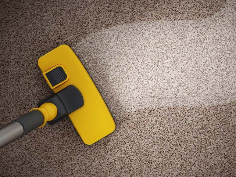 A Yellow Vacuum Cleaner is Cleaning a Brown Carpet — Carpet Pro Care in Alstonville, NSW