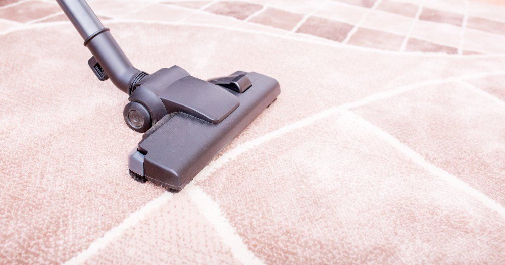 A Vacuum Cleaner is Being Used to Clean a Carpet — Carpet Pro Care in Kyogle, NSW
