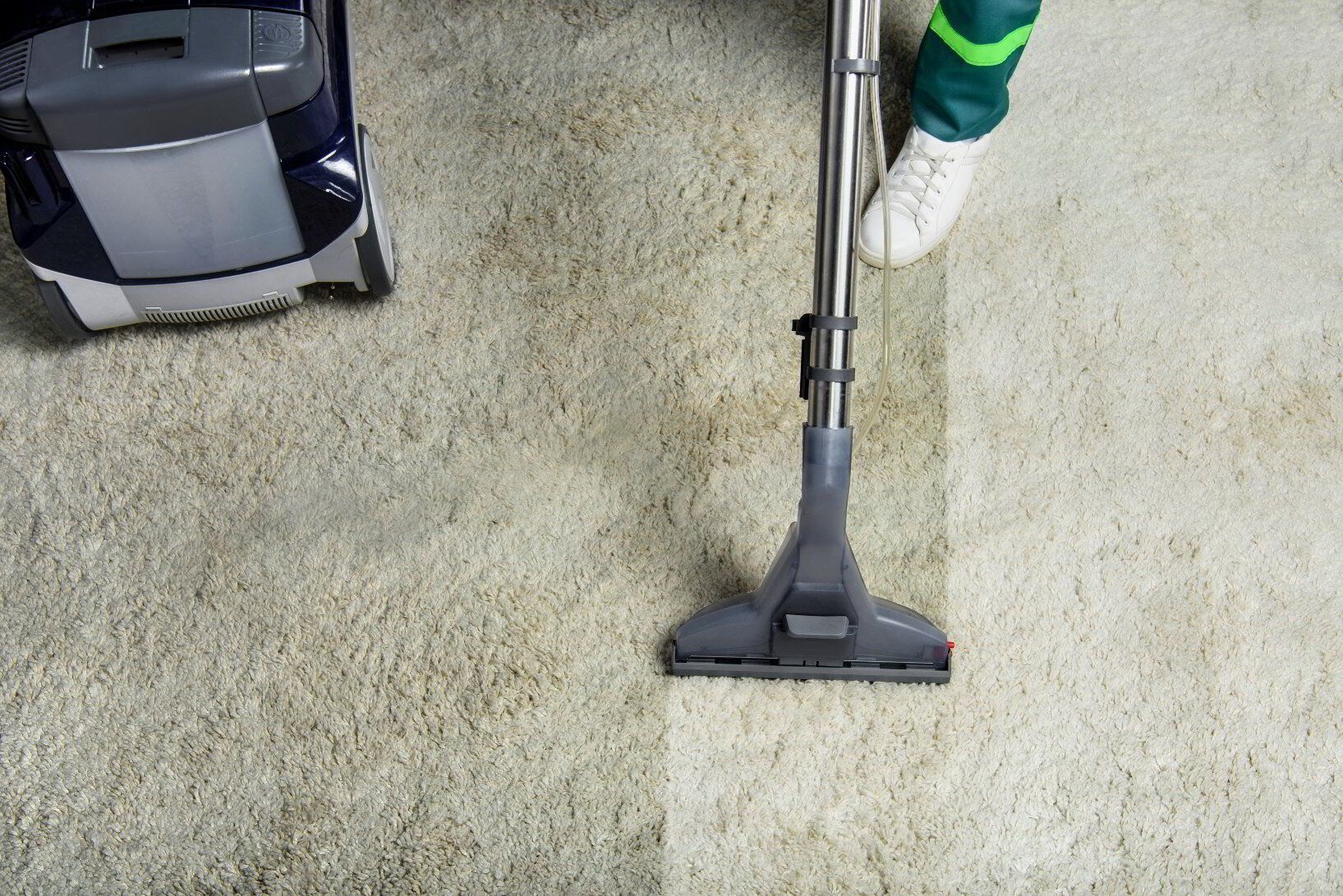 A person is using a vacuum cleaner to clean a carpet  — Carpet Pro Care in Goonellabah, NSW