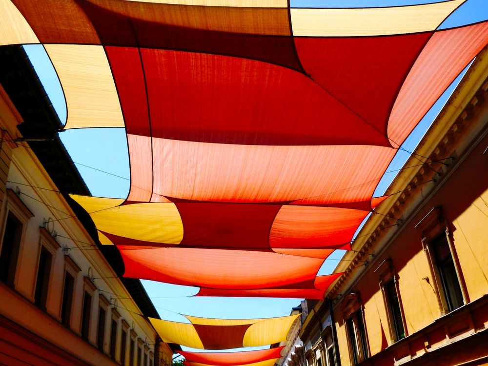 A Row of Colorful Umbrellas Hanging From the Ceiling of a Building — Cooloola Sail Company In Kilkivan, QLD