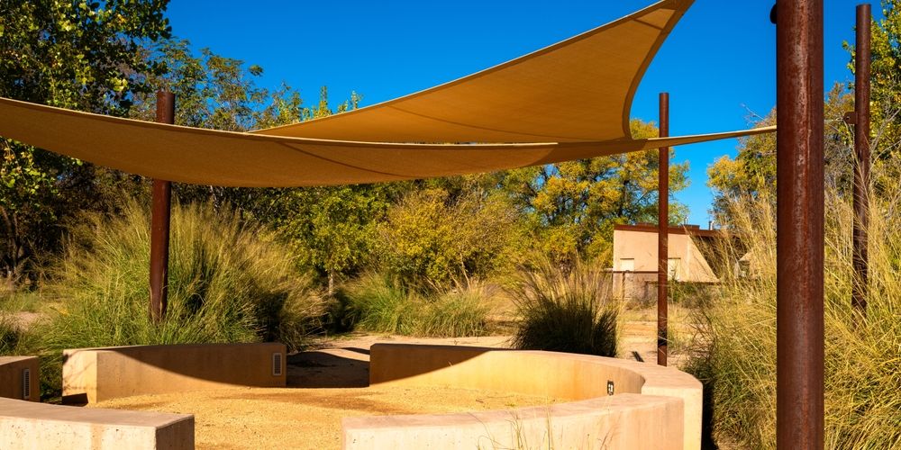 A Large Yellow Umbrella is Sitting in the Middle of a Lush Green Field — Cooloola Sail Company In Kilkivan, QLD