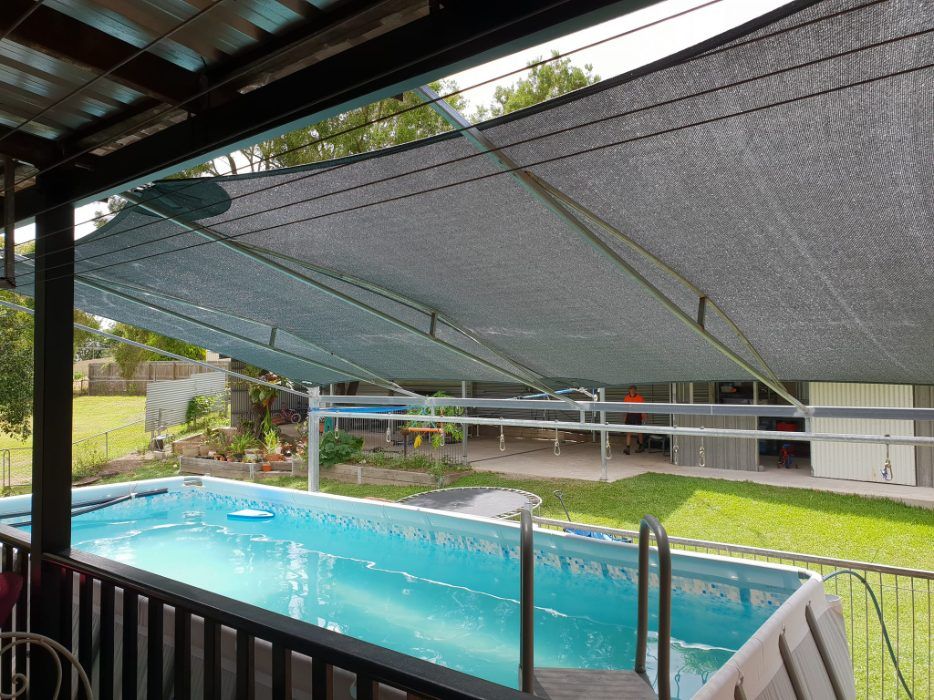 A Large Swimming Pool is Covered With a Shade — Cooloola Sail Company In Southside, QLD