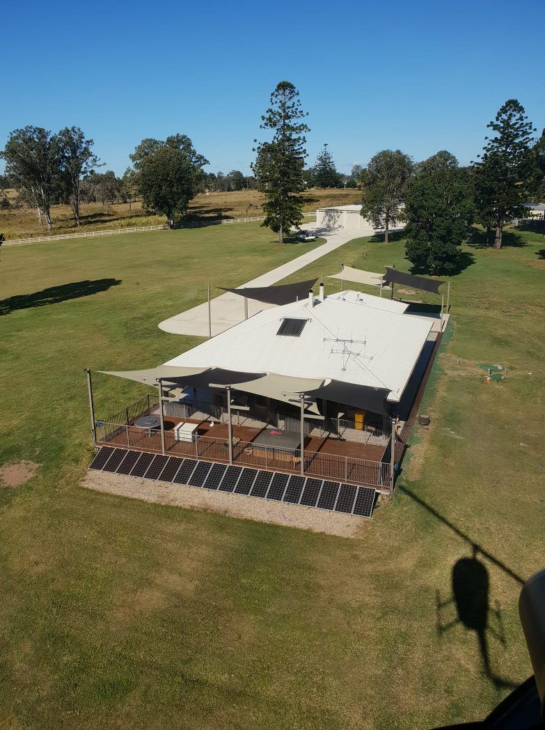 An Aerial View of a House in the Middle of a Grassy Field — Cooloola Sail Company In Rainbow Beach, QLD