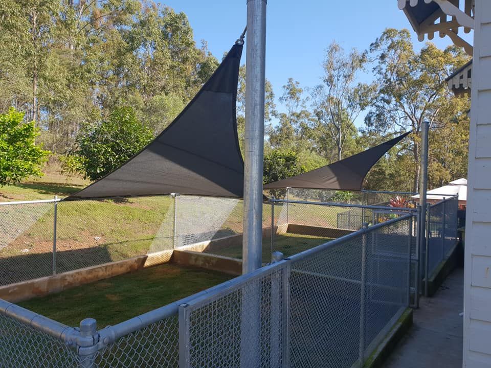 A Fenced in Area With a Shade Sail on Top of It — Cooloola Sail Company In Eumundi, QLD