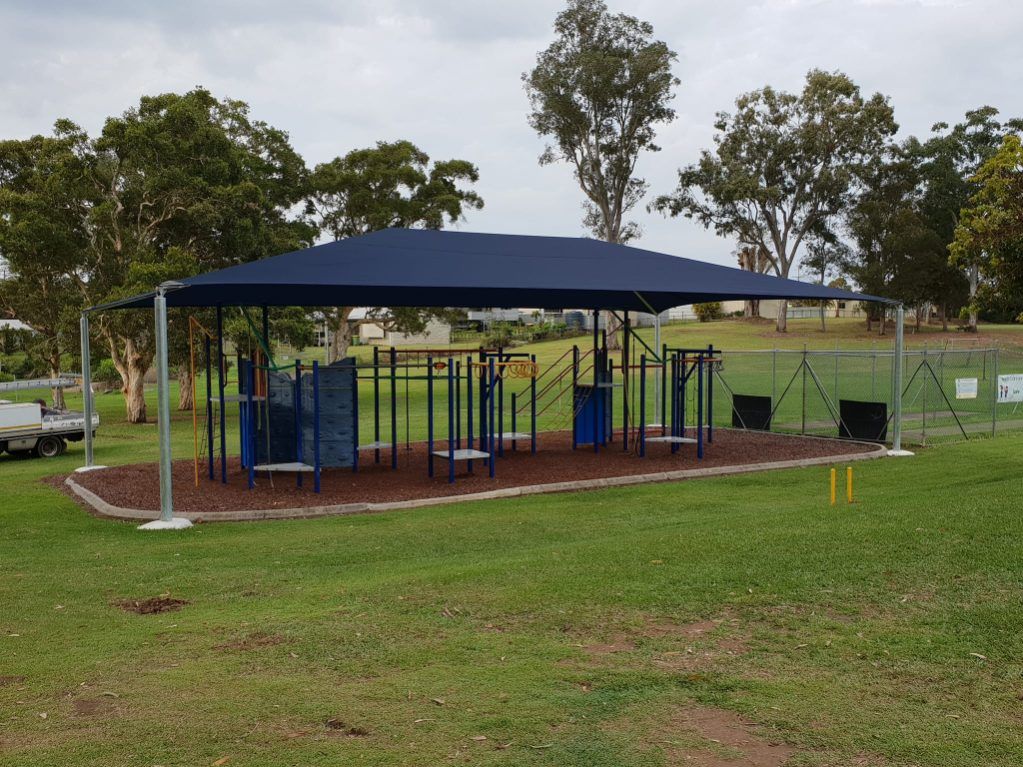 A Playground in a Park With a Blue Canopy Over It — Cooloola Sail Company In Cooroy, QLD