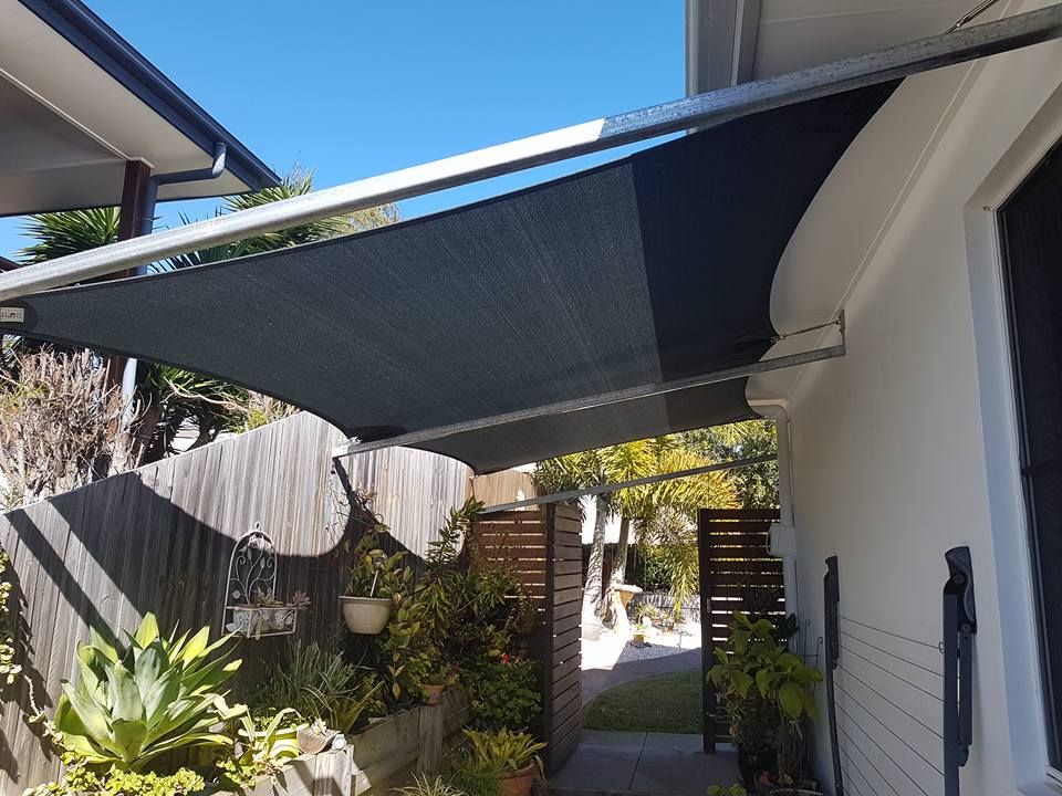 A Row of White Shutters Are Hanging on the Side of a Building — Cooloola Sail Company In Rainbow Beach, QLD