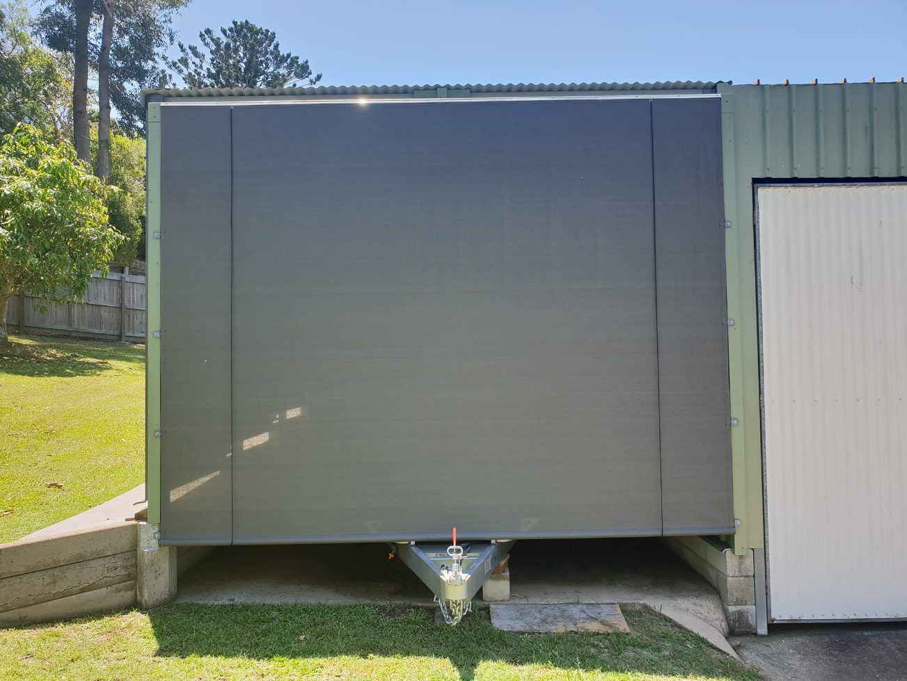 A Trailer is Parked in a Garage Next to a Shed — Cooloola Sail Company In Cooroy, QLD